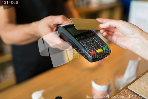 Image of hands with payment terminal and credit card