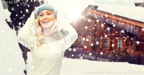 Image of smiling young woman in winter hat and sweater