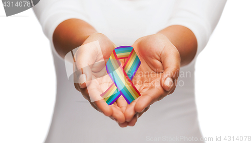 Image of hands holding rainbow gay pride awareness ribbon