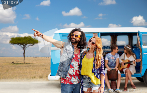 Image of happy hippie couples and minivan in africa