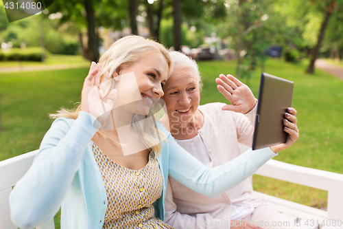 Image of daughter with tablet pc and senior mother at park