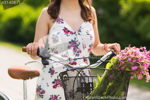 Image of close up of woman with fixie bicycle in park