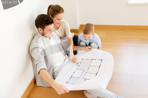 Image of happy family with blueprint moving to new home