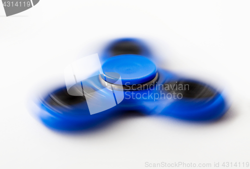 Image of close up of blue spinning fidget spinner