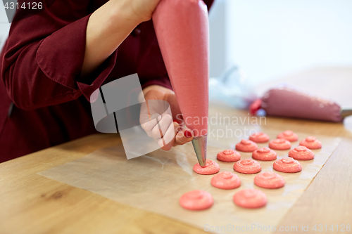 Image of chef with injector squeezing macaron batter