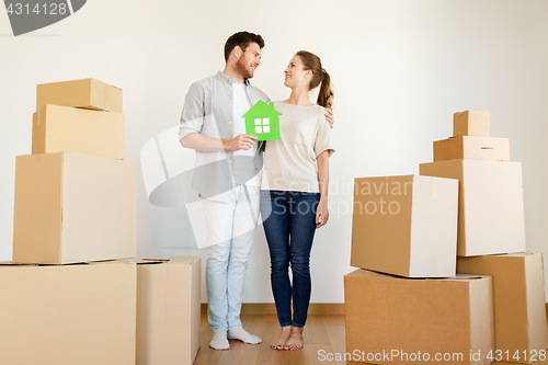 Image of happy couple with boxes moving to new home