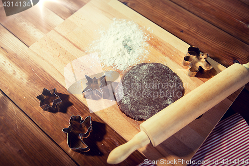 Image of close up of ginger dough, molds and rolling pin