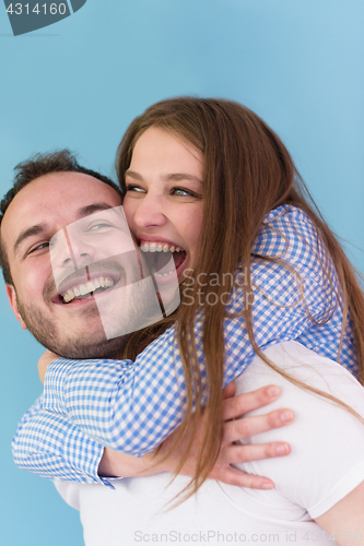 Image of young man piggybacking his girlfriend