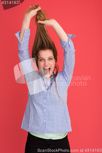 Image of woman playing with her long silky hair