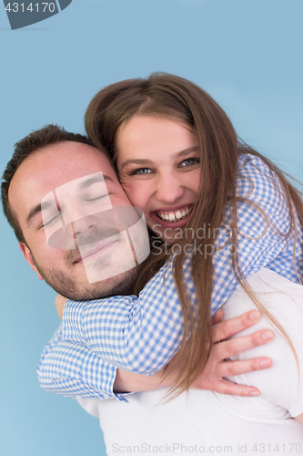 Image of young man piggybacking his girlfriend