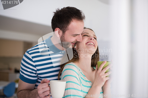 Image of young handsome couple enjoying morning coffee