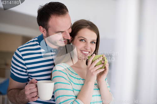 Image of young handsome couple enjoying morning coffee