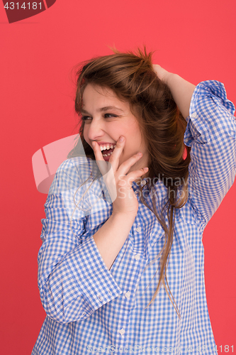 Image of woman playing with her long silky hair