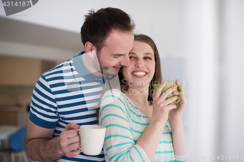 Image of young handsome couple enjoying morning coffee