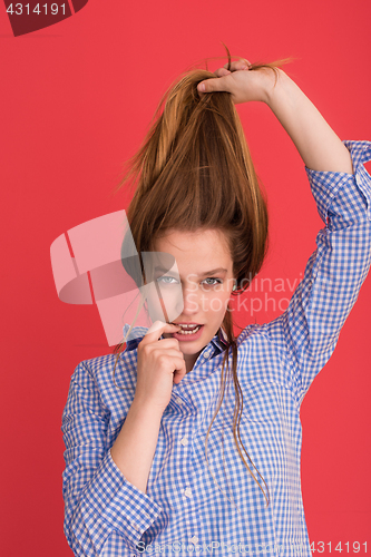 Image of woman playing with her long silky hair