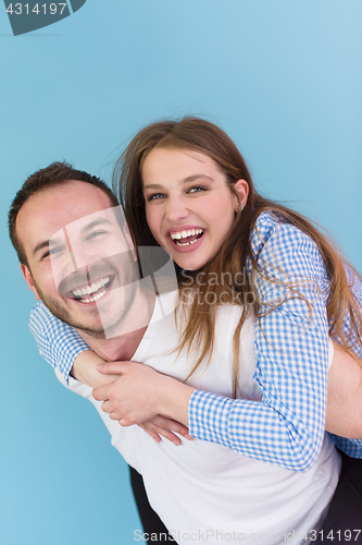 Image of young man piggybacking his girlfriend