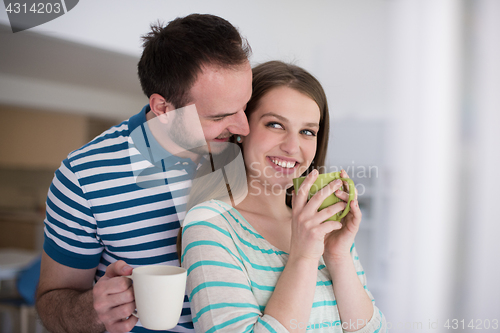 Image of young handsome couple enjoying morning coffee