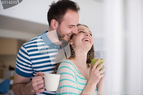 Image of young handsome couple enjoying morning coffee