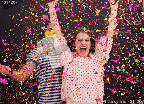Image of couple blowing confetti in the air isolated over gray