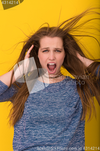 Image of pretty woman playing with her long silky hair