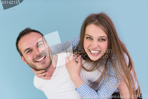 Image of young man piggybacking his girlfriend