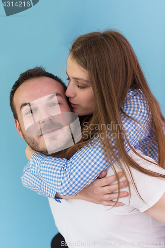 Image of young man piggybacking his girlfriend