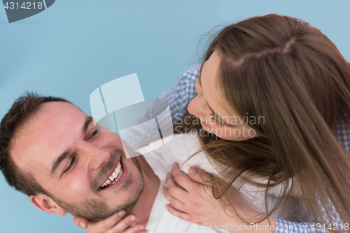 Image of young man piggybacking his girlfriend