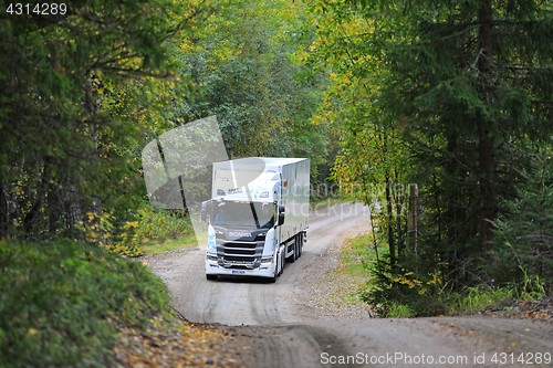 Image of White Next Generation Scania Semi in Autumn Forest 