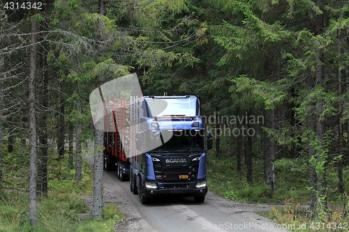 Image of New Scania R650 XT Logging Truck on Forest Road