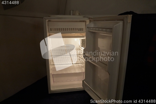 Image of Empty refrigerator in the dark