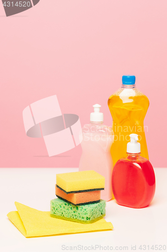 Image of Various bottles with cleaning supplies on colored background