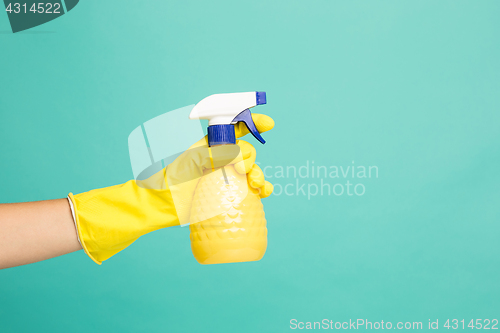 Image of Close up picture of a house-cleaning spray on a blue background