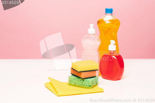 Image of Various bottles with cleaning supplies on colored background