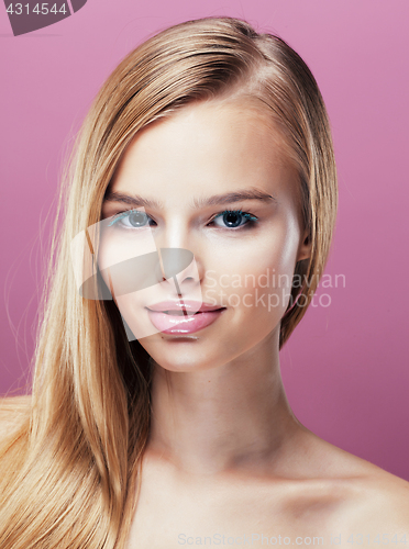 Image of young pretty blonde woman with hairstyle close up and makeup on pink 