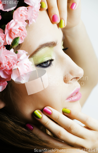 Image of Beauty young real woman with flowers and make up closeup