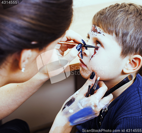 Image of little cute child making facepaint on birthday party, zombie Apo