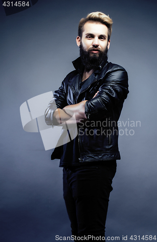 Image of portrait of young bearded hipster guy on gray dark background close up, brutal modern man, lifestyle people concept 