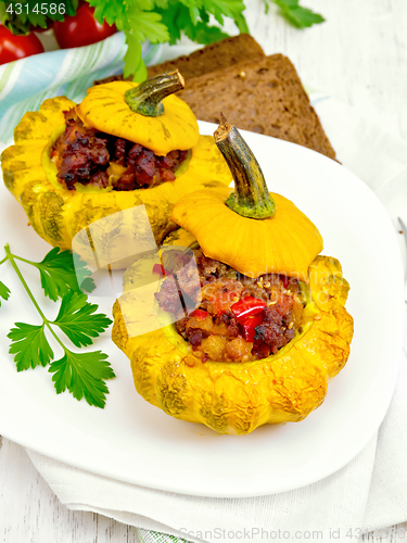 Image of Squash yellow stuffed with meat on light board
