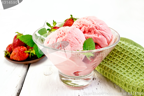 Image of Ice cream strawberry in glass with berries on light board