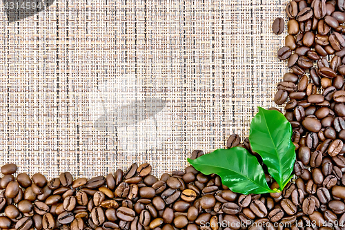 Image of Coffee black grains on brown woven fabric