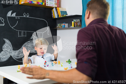 Image of Cute little toddler boy at child therapy session.