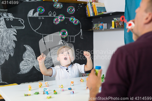 Image of Cute little toddler boy at speechtherapist session.