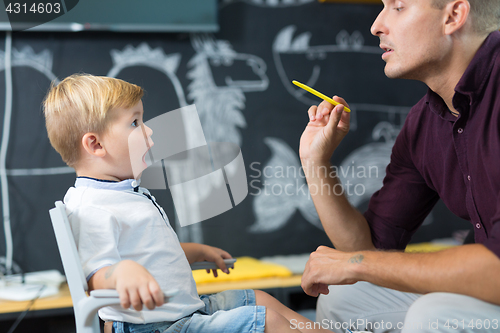 Image of Cute little boy at speechtherapist session.