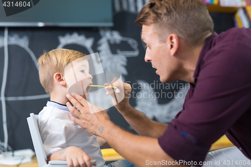 Image of Cute little boy at speechtherapist session.