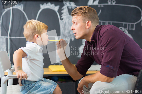 Image of Cute little boy at speechtherapist session.