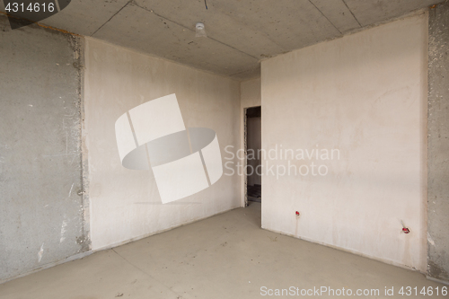 Image of Entrance to the room in the new building, plastered and concrete walls