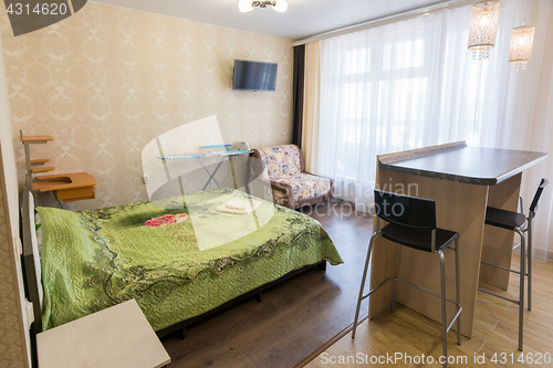 Image of Interior of a bedroom with a sofa in a one-room apartment