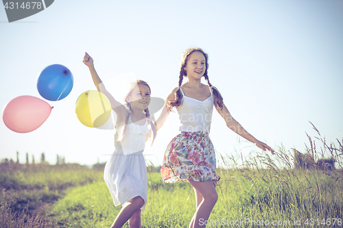 Image of Happy little children playing in the field at the day time.