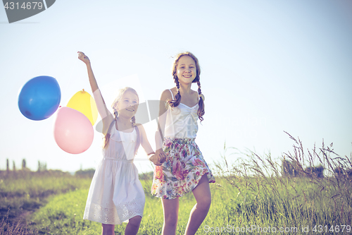 Image of Happy little children playing in the field at the day time. 