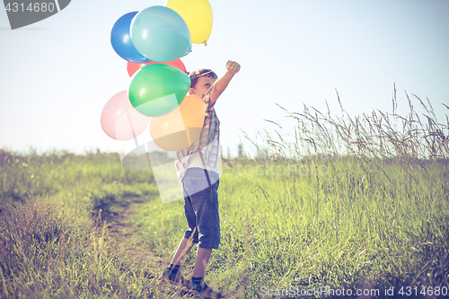 Image of Happy little boy playing on road at the day time.